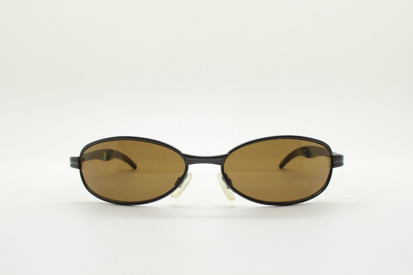 90s vintage oval small bug eye sunglasses. Curved brown satin finish solid metal frame with spear point rubber ends. Steampunk. Quality NOS