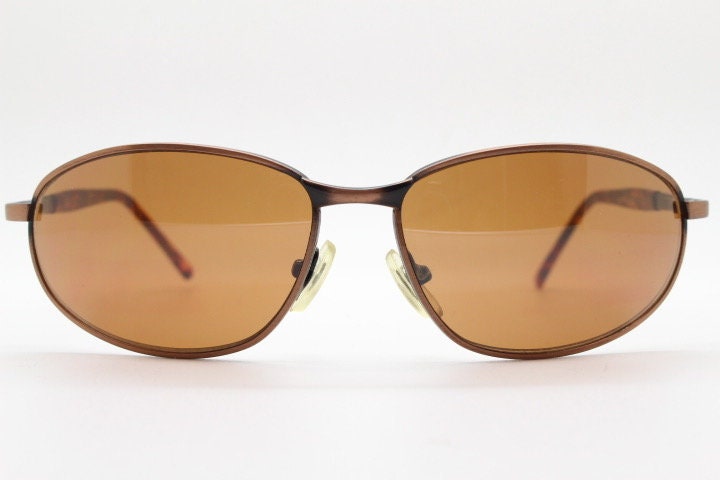 Y2K vintage small bug eye aviator sunglasses. Curved copper brushed finish solid metal frame with tortoise arms. Unused 2000s NOS
