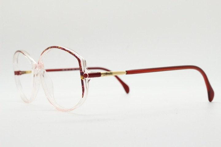 Silhouette 80s vintage hexagon eye glasses made in Austria. Transparent crystal optical frame with abstract red pattern. Prescription RX