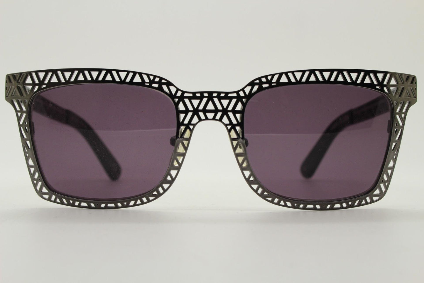 Sass and bide vintage wayfarer shape sunglasses. Gunmetal grey flat metal frame with cut out patterns throughout and black lenses. 2000s NOS
