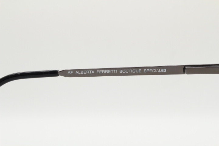 Alberta Ferretti 90s vintage oval eye glasses made in Italy. Small grey metal optical frame with ornate arm pattern. Prescription RX. NOS