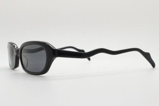 90s vintage rectangular minimal cat eye sunglasses. Small black acetate low profile frame with extraordinary waved arms. Unused NOS