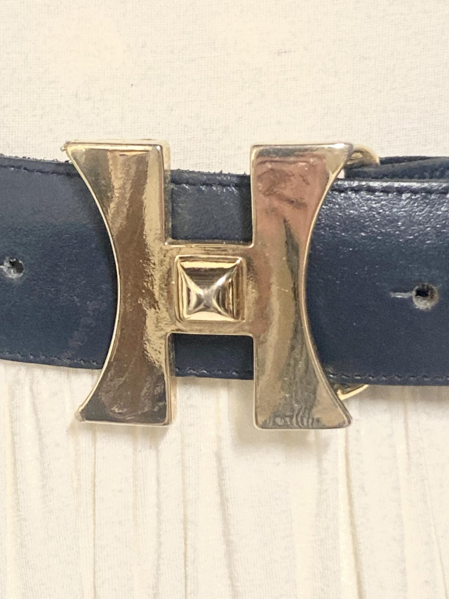 80s vintage womens dress belt in navy blue genuine leather with substantial gold chrome studded 'H' motifs. Made in France. Size S