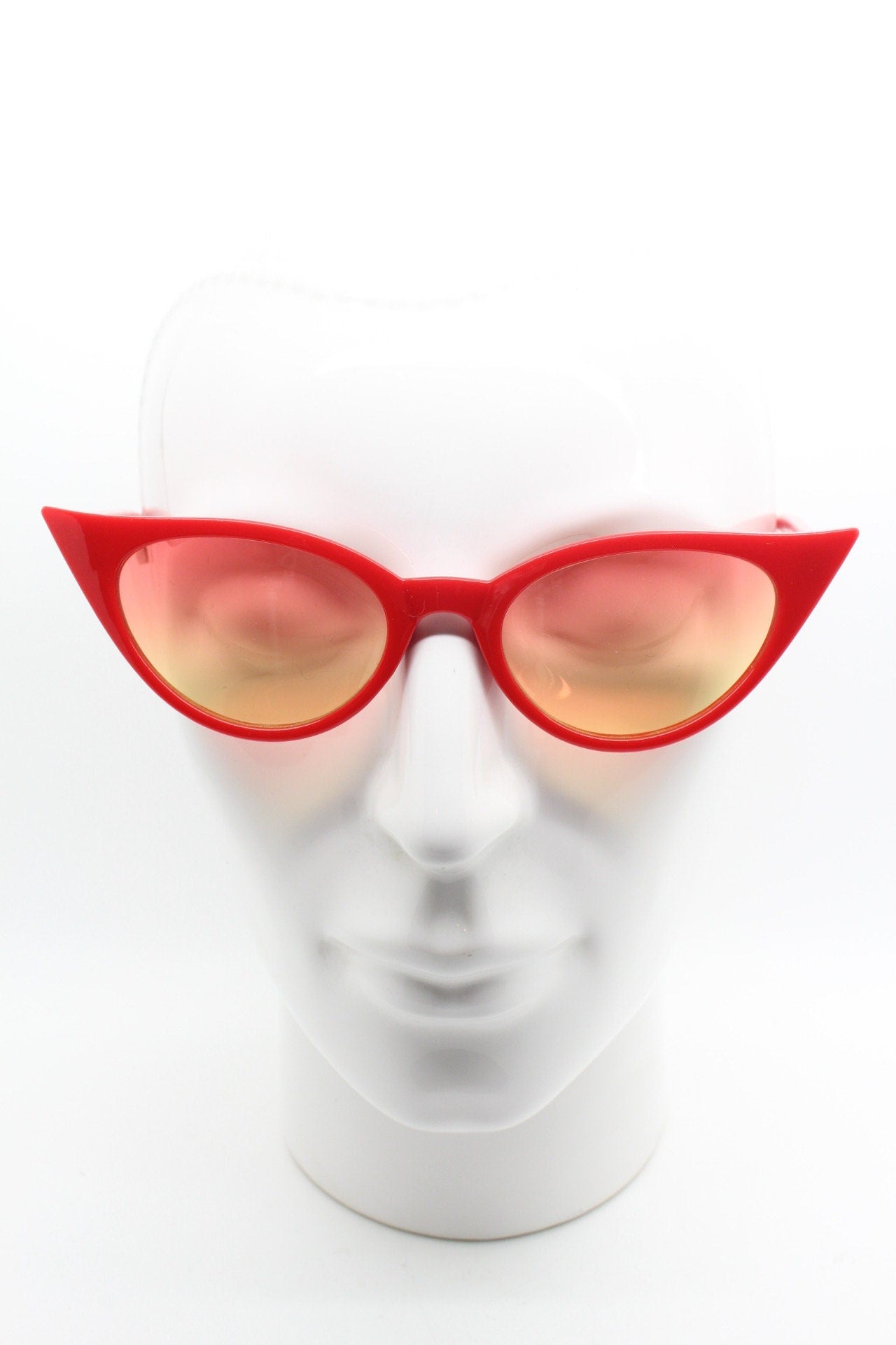 Y2K vintage pointed cat eye sunglasses. Red slender frame with graduating lenses. Womens 50s style rockabilly, pin up shades