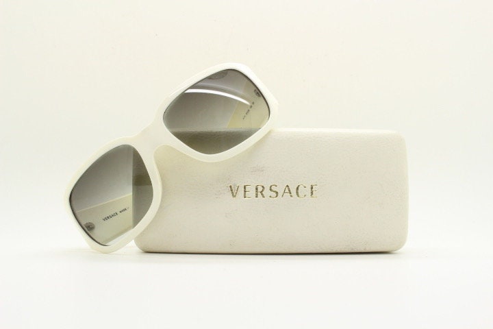 Versace Y2k vintage wrap around bug eye sunglasses. Curving white acetate shield frame with huge spell out diamante logo. 2000s. Rhinestone