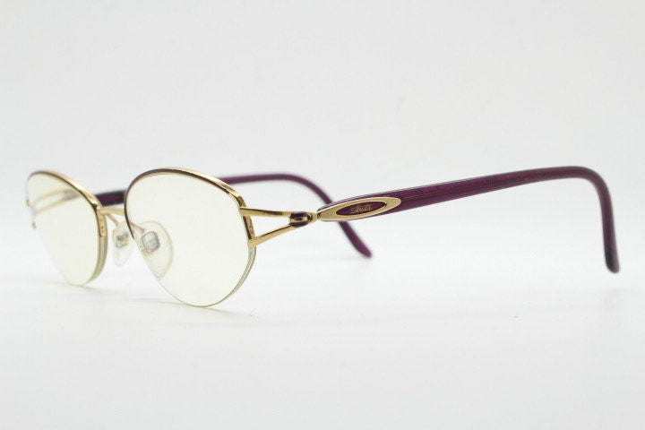 Silhouette oval half frame eye glasses model 6566 made in Austria. Minimal optical frame with gold trim deep purple arms. Prescription RX