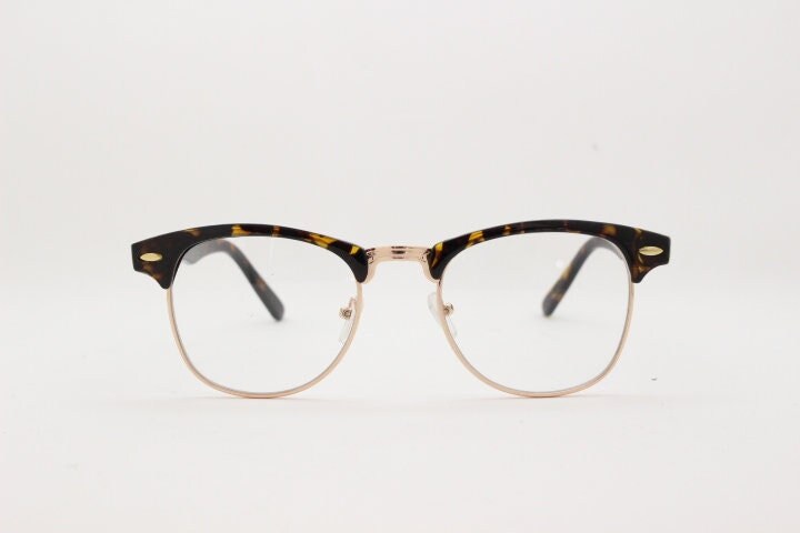 90s vintage half frame glasses. Tortoise browline eyeglasses in a gloss finish with gold underwire and clear lenses . Mens 50s, 60s design