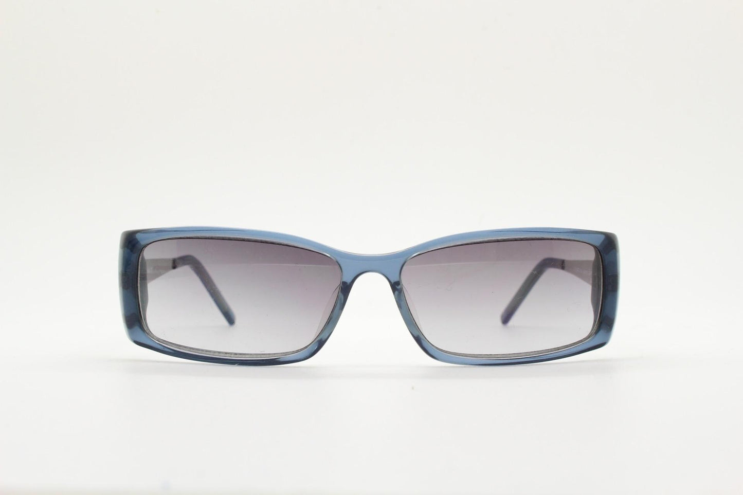 90s vintage rectangular low profile sunglasses by Storm. Transparent grey acetate front with brushed steel arms. NOS. 2000s