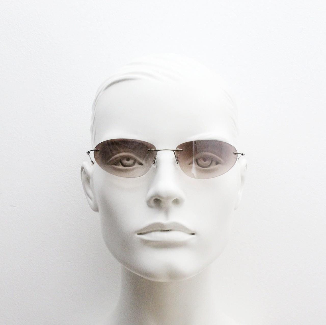90s vintage frameless oval wraparound sunglasses. Minimal curved almond shaped lenses with brown chrome arms. 2000s NOS. Matrix cosplay