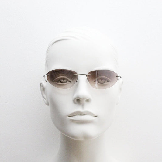 90s vintage frameless oval wraparound sunglasses. Minimal curved almond shaped lenses with brown chrome arms. 2000s NOS. Matrix cosplay