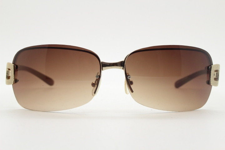 Y2K vintage rectangular brown sunglasses. Gold half frame 2000's wrap around with curved lenses, gold trim and temple crests. Unused NOS