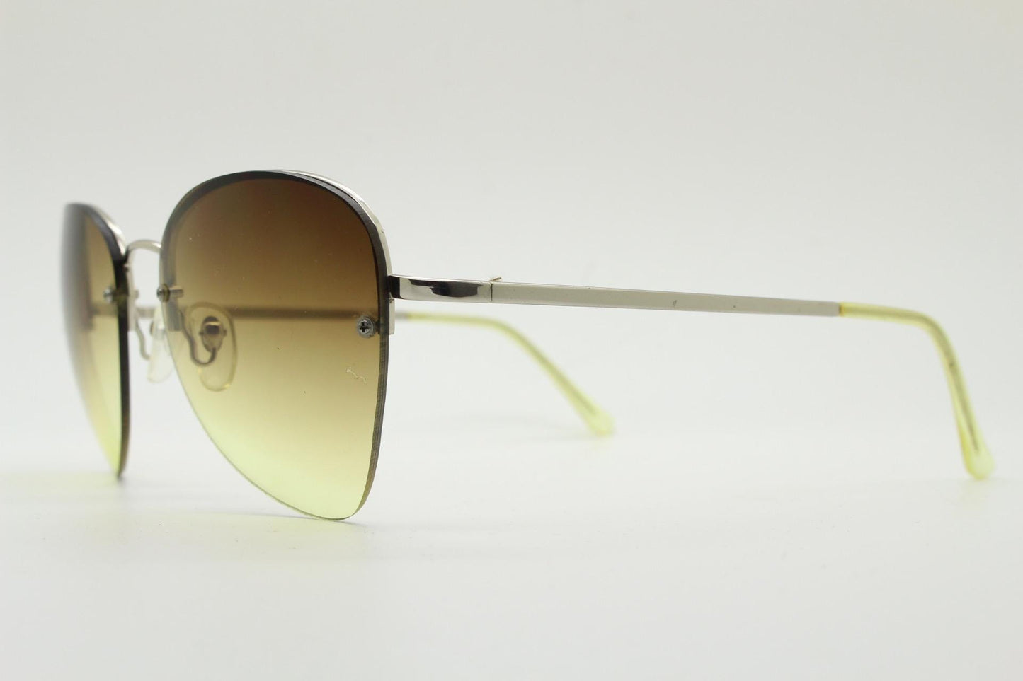 90s vintage modified teardrop aviator sunglasses. Minimal metal silver chrome half frame with compelling lenses. Teardrop aviators. NOS
