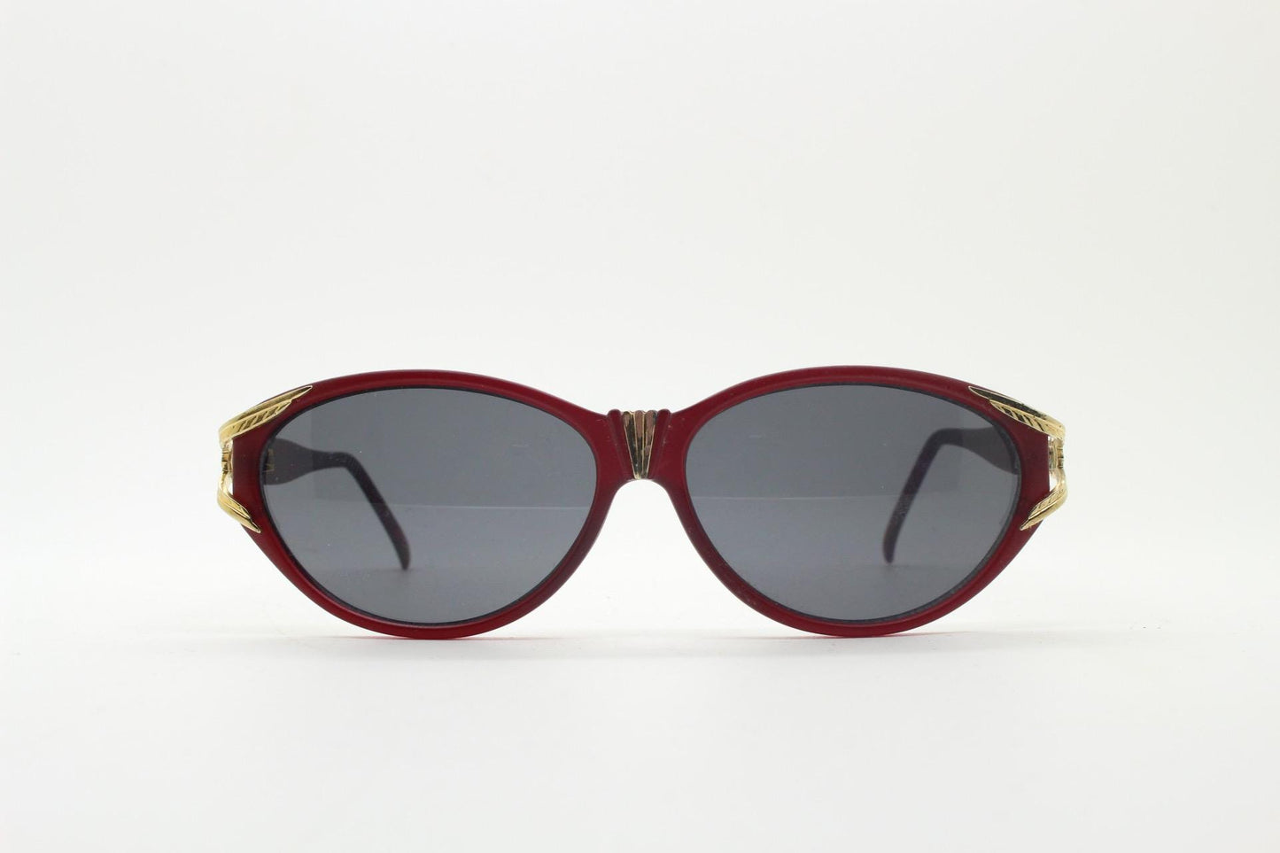 80s vintage Revlon cat eye sunglasses. Women's dark pink transparent frosted frame with golden Y fork ornate temples. 90s cateye. NOS