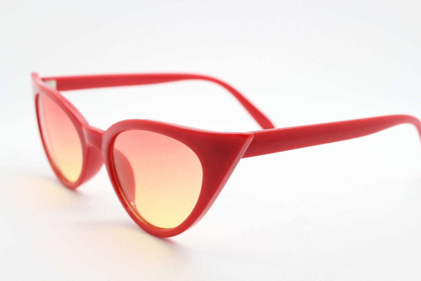 Y2K vintage pointed cat eye sunglasses. Red slender frame with graduating lenses. Womens 50s style rockabilly, pin up shades