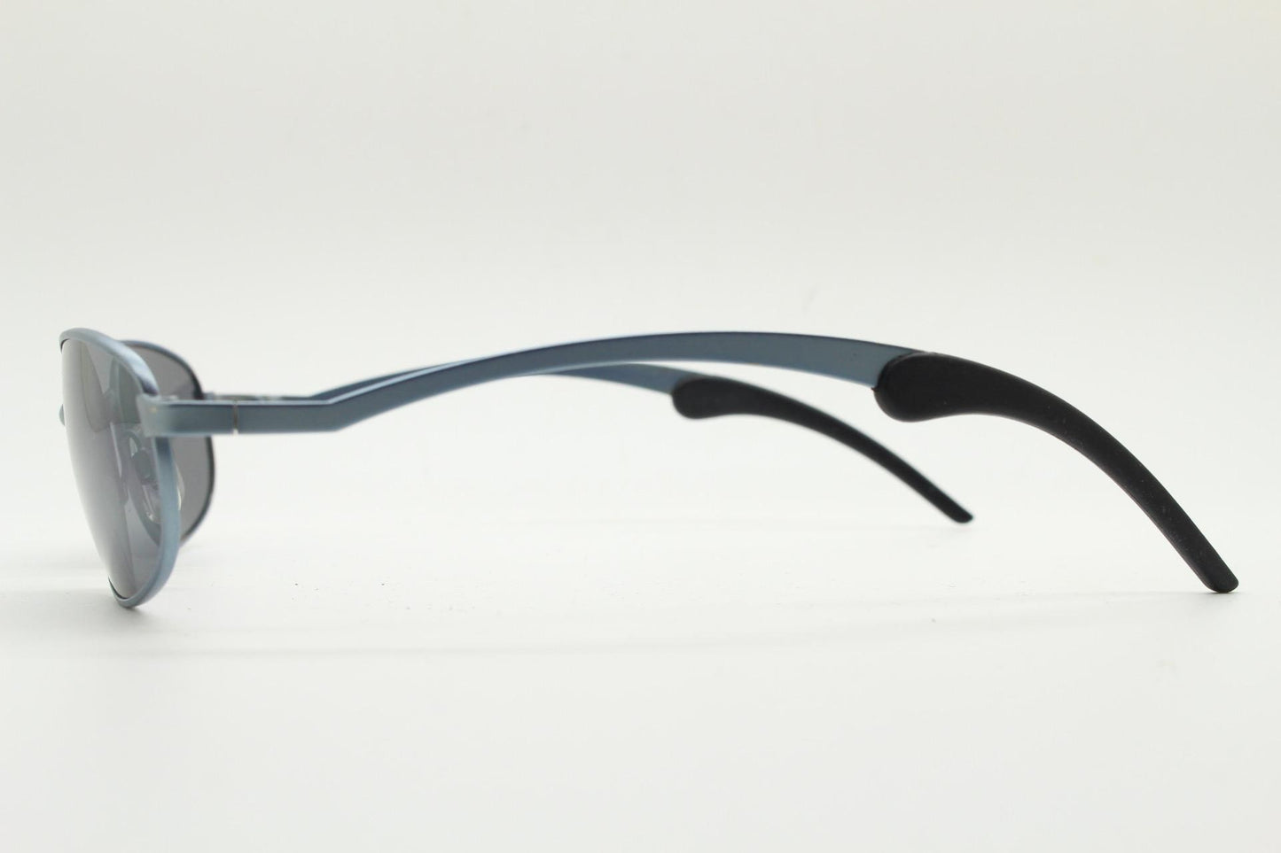 90s vintage oval small bug eye sunglasses. Curved blue satin finish solid metal frame with stylised arched arms and rubber ends. Unused NOS