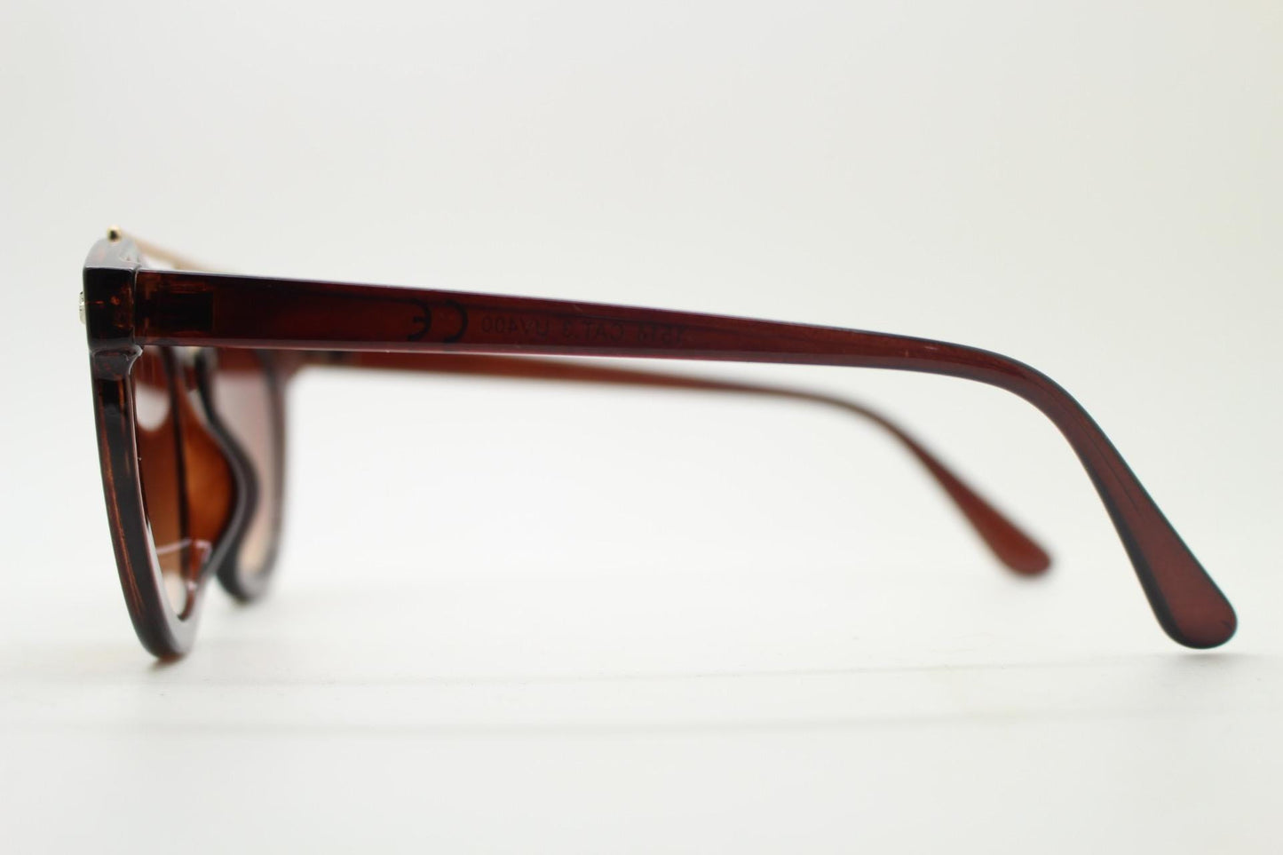 Rounded cateye sunglasses with gold 'scaffold' metal bridge. Women's transparent frame with matching brown graduating lenses. Vintage NOS