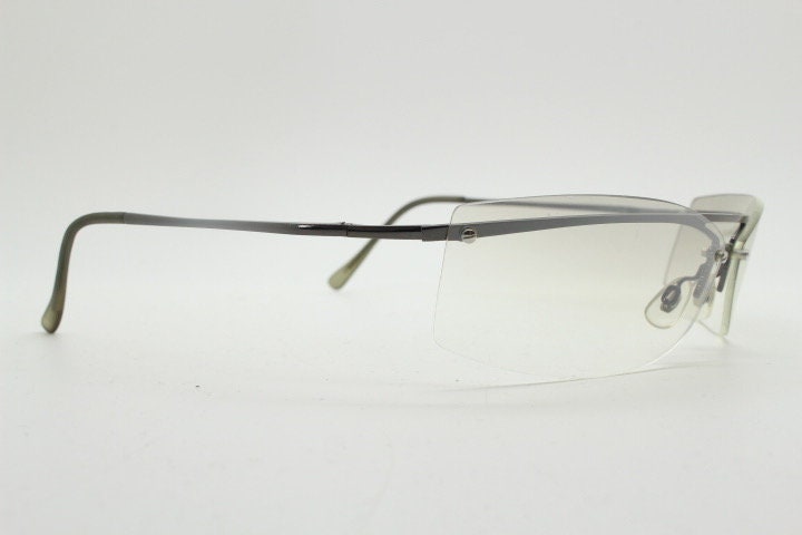Y2K vintage wraparound sunglasses. Sick fashion grail half frame in grey chrome with extra light tone curving mirrored lenses. 2000's NOS