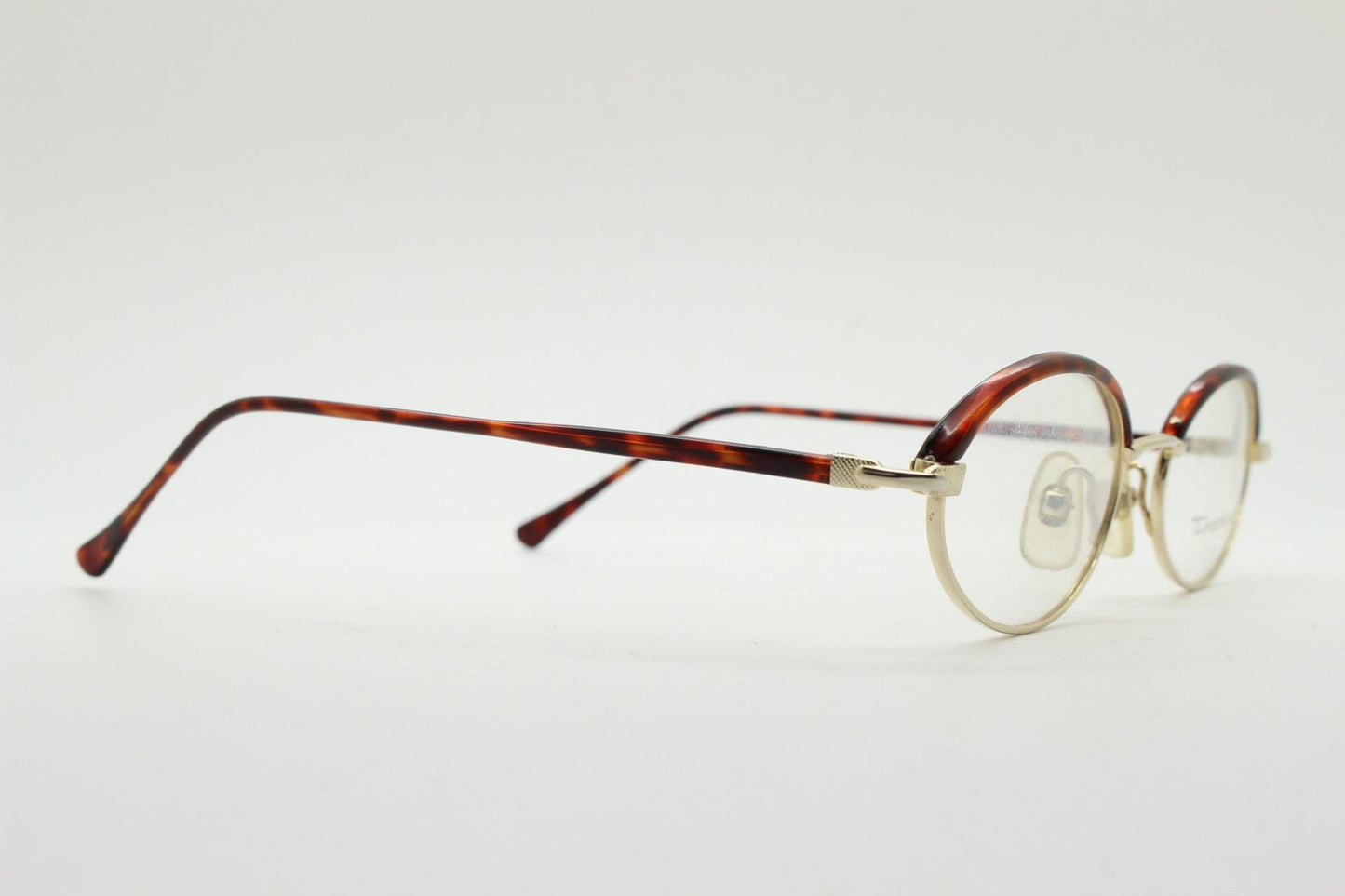 90s vintage small oval eye glasses by Tropical. Minimal gold optical frames with tortoise arms and brows. Prescription RX spectacles. NOS