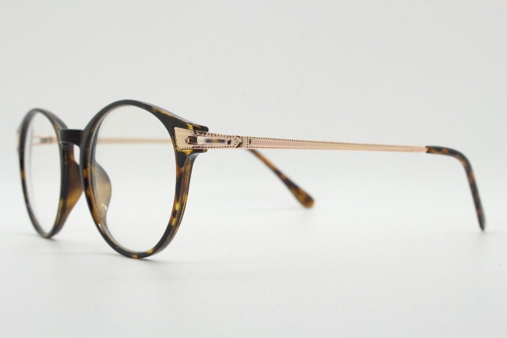 90s vintage round glasses with tortoise front and gold embossed arms. 40s, 50s style prescription optical frames. Clear lens eyeglasses. RX