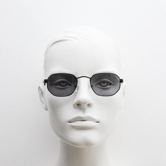 Prestige 90s vintage small oval sunglasses model 119 made in Italy. Black matt metal frame with with subtle angular facets, NOS octagon