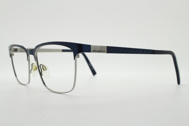Karl Lagerfeld squared wayfarer shape eye glasses. Navy check pattern arms with satin finish brow optical frames. Prescription eyeglasses.