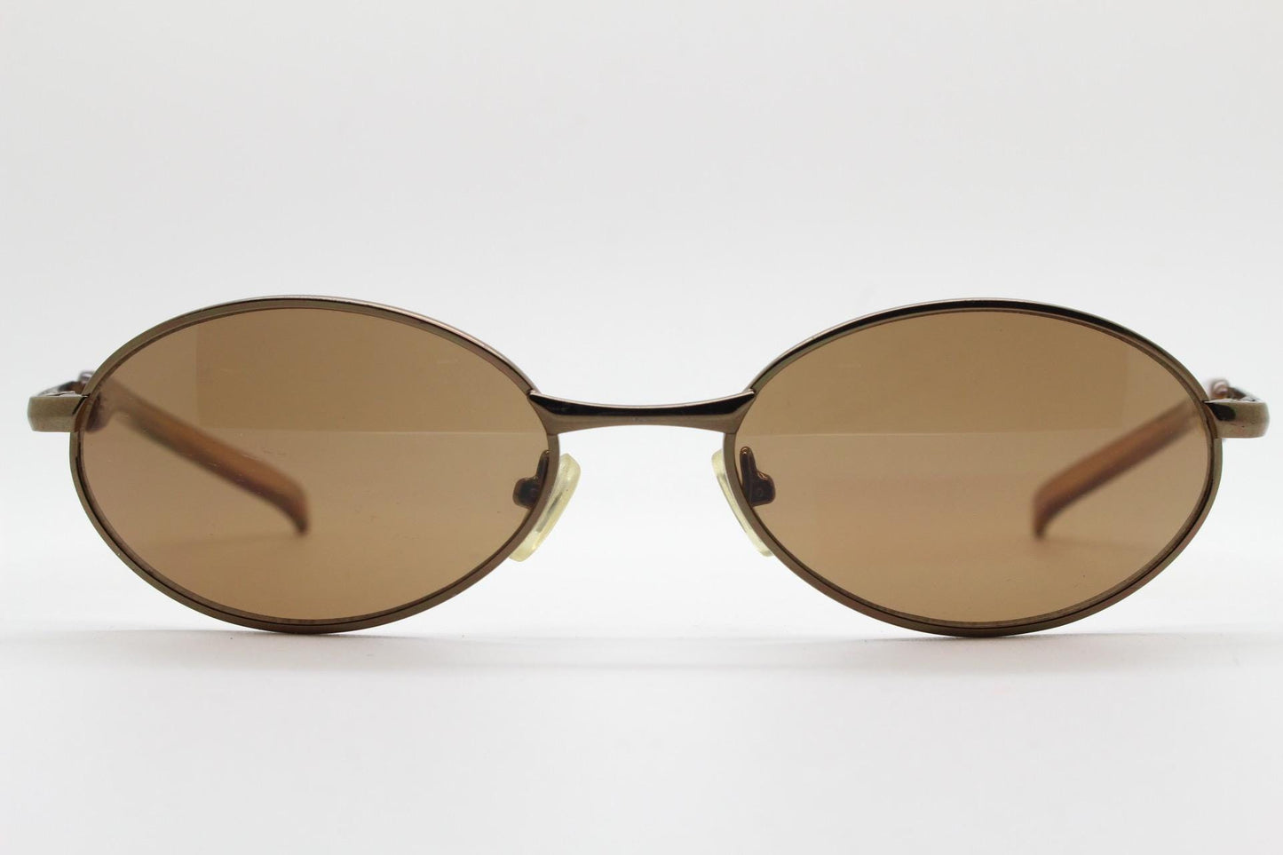 90s vintage small oval bug eye sunglasses. Minimal brown chrome finish metal frame with transparent curved arms. Y2K. Unused NOS
