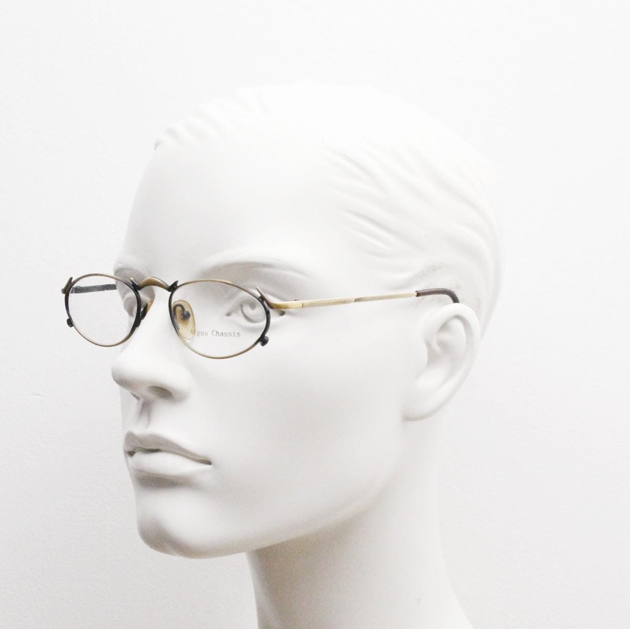 90s vintage oval eye glasses by Argus Chassis. Brushed bronze optical frames with dynamic spikes. Prescription cosplay fetish spectacles NOS