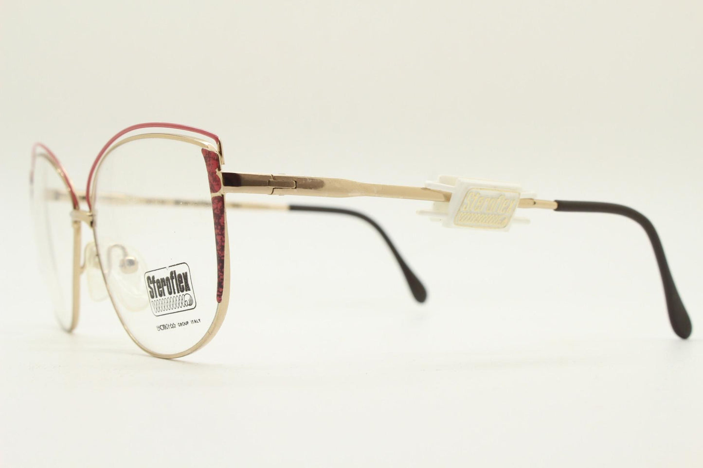 Luxottica 80s vintage gold metal eye glasses made in Italy. Inventive double brow with red highlights. Optical frame. Prescription NOS