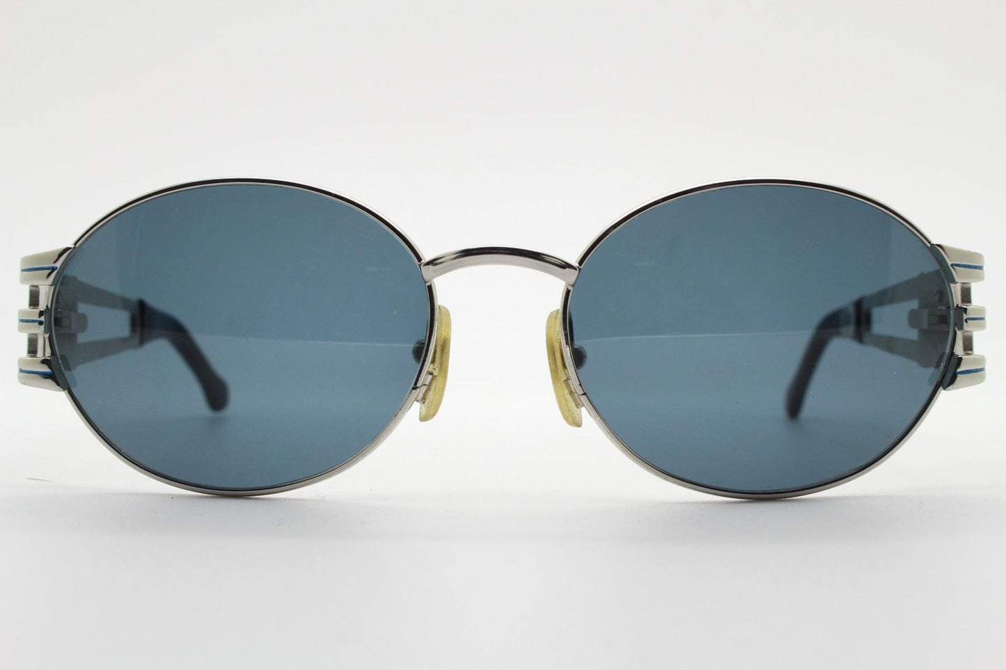 Sunsweet 90s vintage metal oval sunglasses made in Italy. Definitive ornate temple design with classical sun crests in silver chrome. NOS