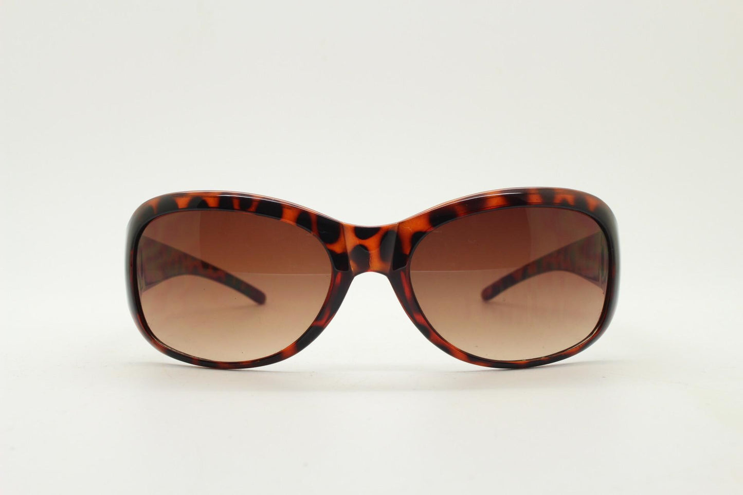 Y2k vintage wrap around bug eye sunglasses. Curved tortoise gloss frame with gradient Havana brown lenses. 2000's NOS