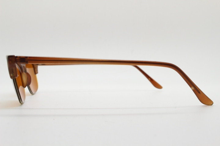 90s vintage low profile cat eye sunglasses. Transparent half frame cateye with matching mirror glazed light tone lenses. NOS