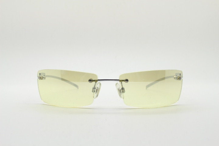 Y2K vintage rectangular sunglasses. Minimal frameless light tone curved mirrored lenses with silver chrome trim. 2000's. 90s. 00s. NOS