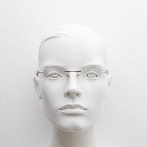 Vogue vintage frameless oval eye glasses. Transparent acetate arms with purple and green tones. Minimal Prescription RX Optical frame