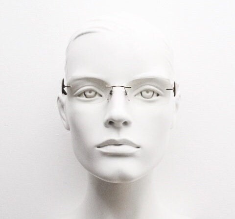 Silhouette rectangular frameless eye glasses model 7599 made in Austria. Minimal optical frame with transparent brown arms. Prescription RX