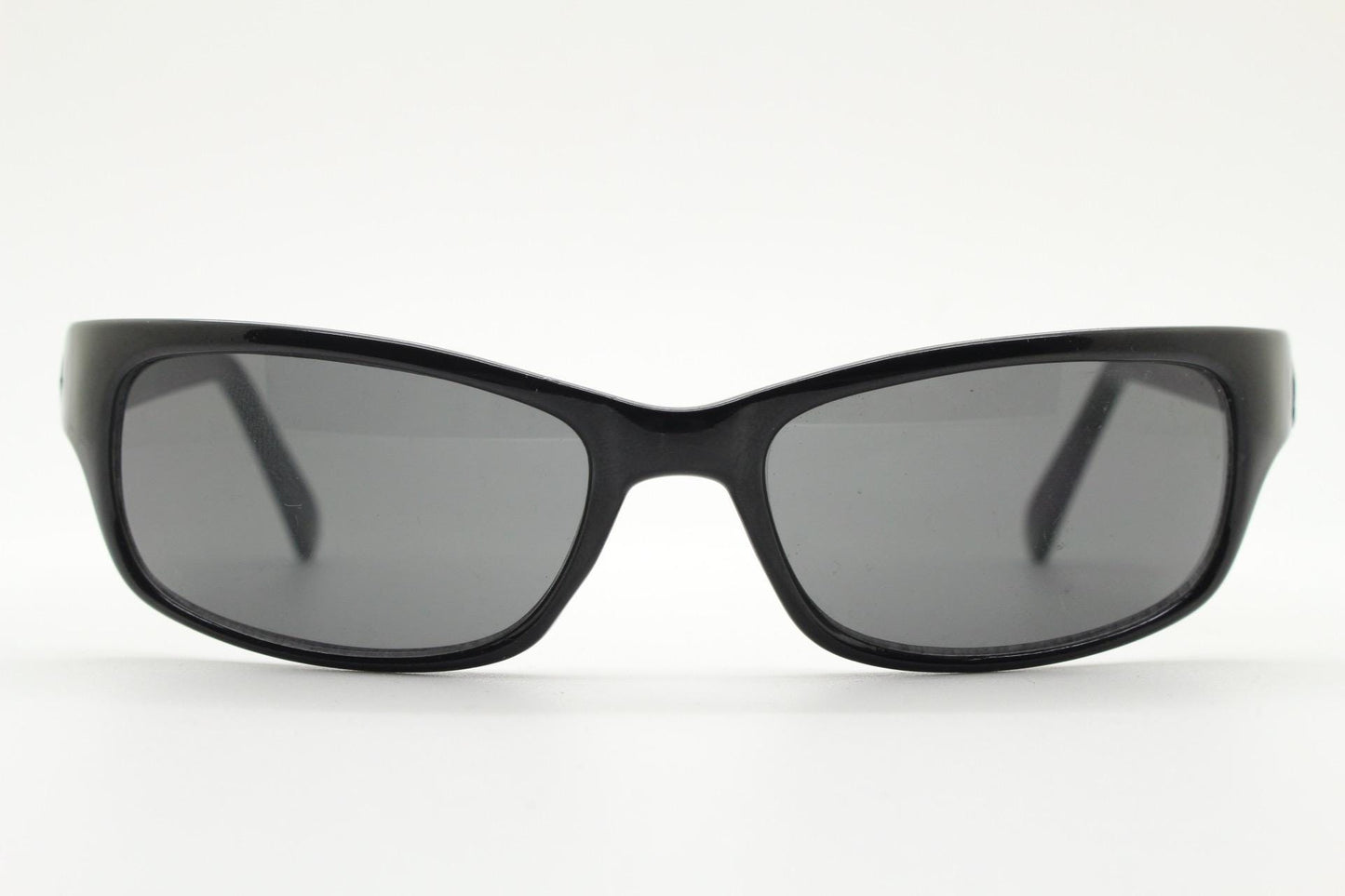 90s vintage curved wraparound sunglasses. Aerodynamic low profile plain black gloss curved cat eye frame. Minimal shield design. NOS