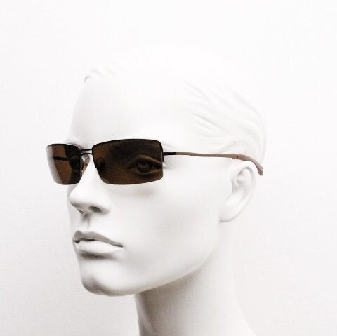 Y2K vintage curved rectangular sunglasses. Minimal half frame in brown chrome with mid tone lenses and straight arms. 2000's. 00's NOS