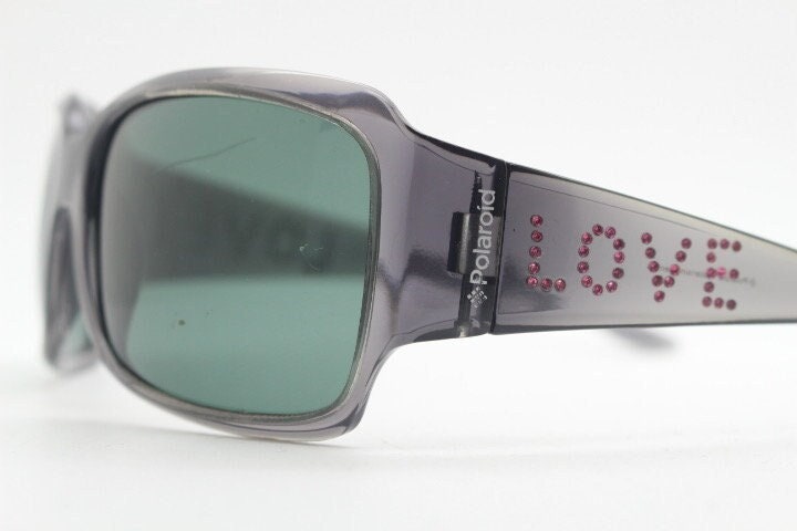 Polaroid Y2K vintage shield sunglasses. Transparent grey wrap around with red diamante LOVE logo and polarising lens. 2000s. Rhinestone