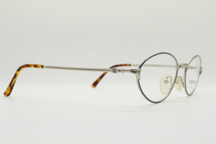 Viennaline 90s vintage oval eye glasses made in italy from titanium. Satin silver optical frame with grey enamel outline. Prescription RX