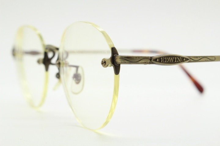 Edwin vintage 90s frameless round eye glasses model 59392A made in Japan. Minimal satin bronze finish optical frame. Prescription RX