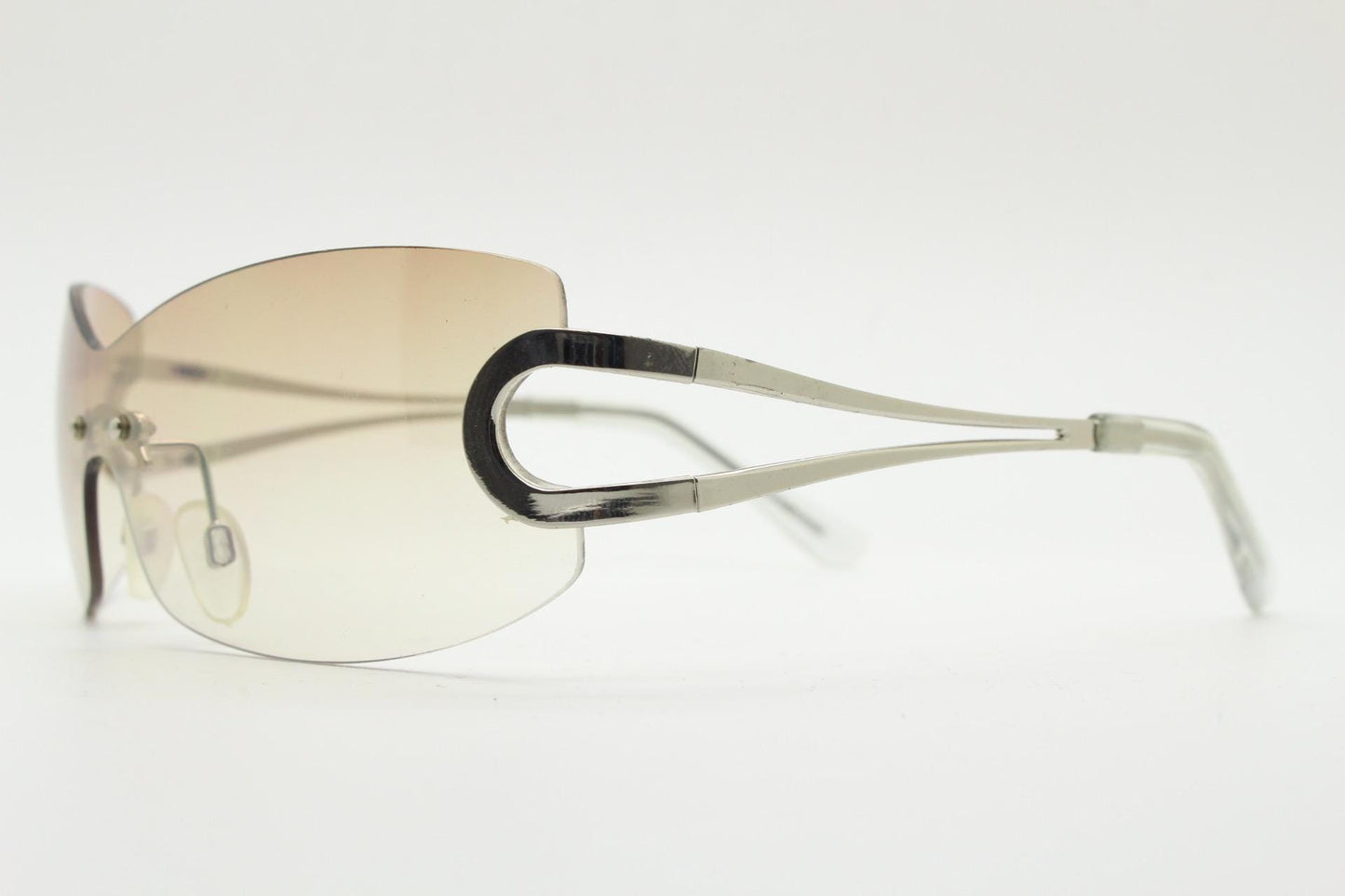 Y2K vintage visor sunglasses. 2000's brown wraparound mono lens shield design with looped chrome temples. 00s uber fashion mini mask NOS
