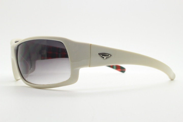 Uvex Y2k vintage wrap around bug eye sunglasses. Curving white sports shield frame with black lenses and tartan interior. Rave 2000s. NOS