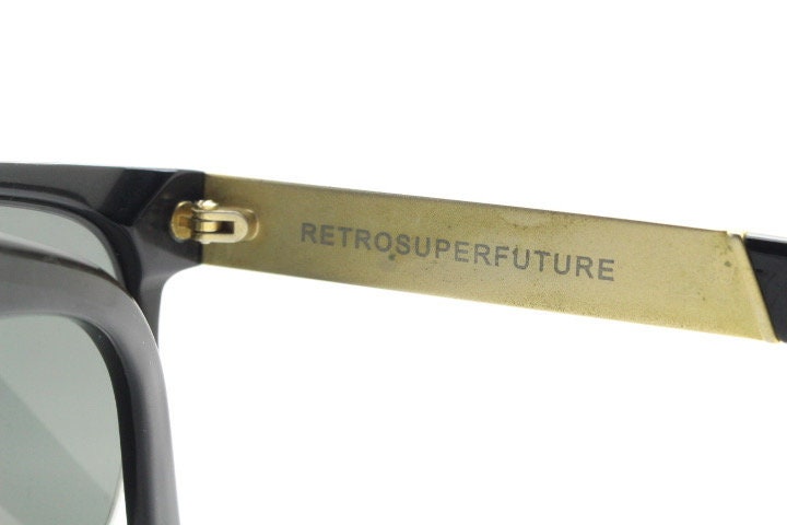 Retrosuperfuture vintage flat top half frame sunglasses hand made in Italy. Black gloss acetate front with tall golden arms