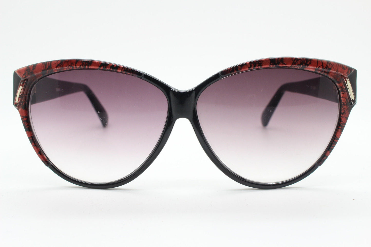 80s vintage oversized cateye sunglasses. Women's black cat eye frame with red patterned brow and sizzling gradient lenses