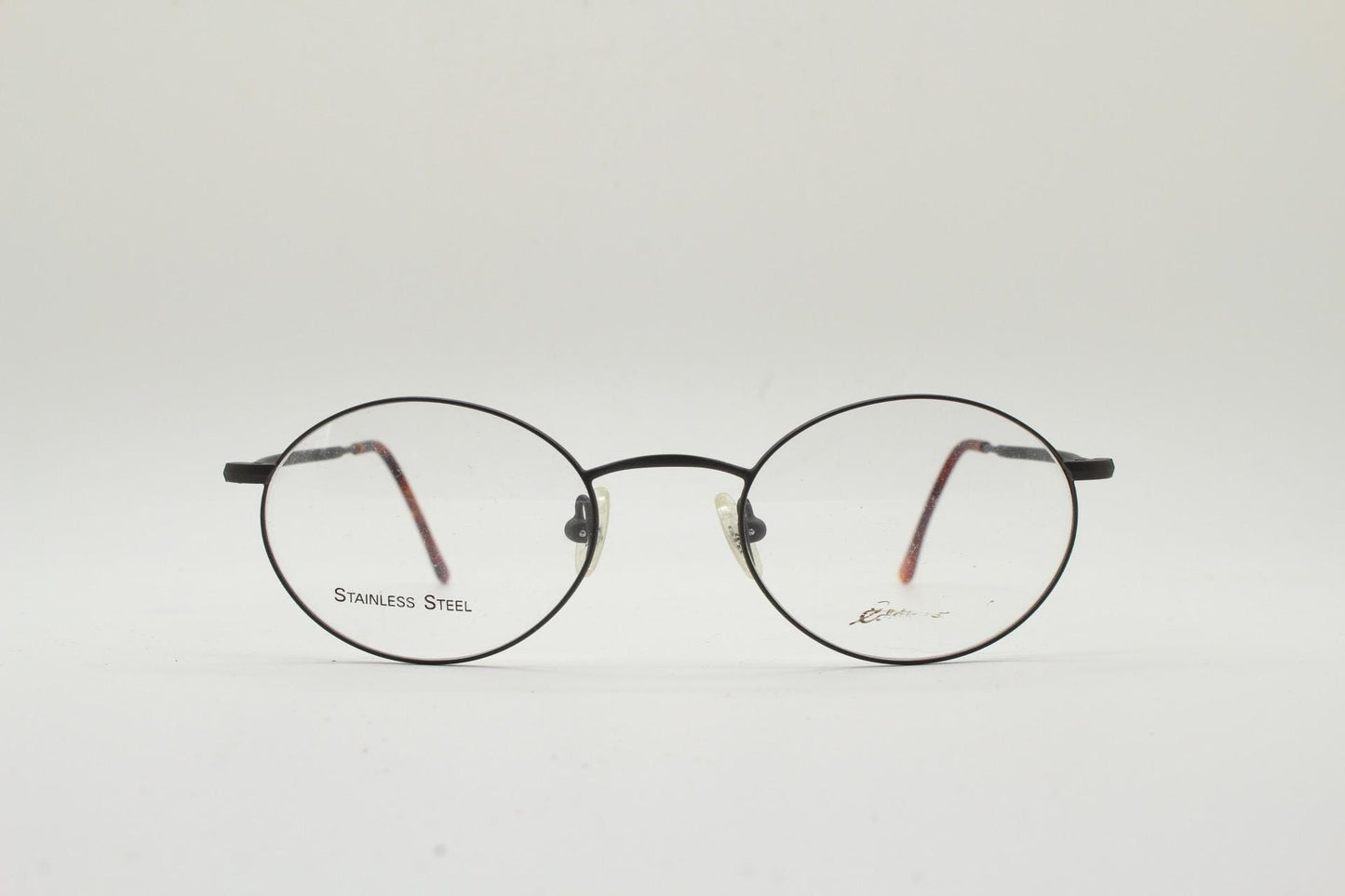 Eddie Bauer 90s vintage oval eye glasses. Minimal black matt finish optical frames with kinked arms. Stainless steel spectacles. NOS