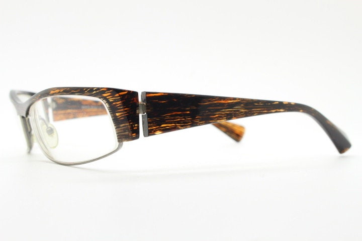 Alain Mikli 90s vintage eye glasses hand made in France. Low profile wrap around half frame in 'wood grain' acetate. Optical prescription RX