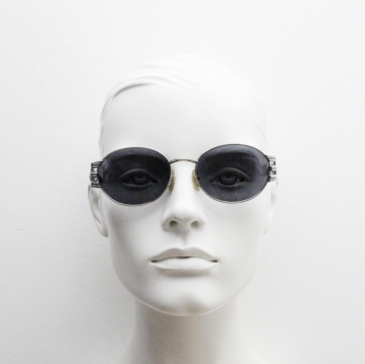 Sunsweet 90s vintage metal oval sunglasses made in Italy. Definitive ornate temple design with classical sun crests in silver chrome. NOS