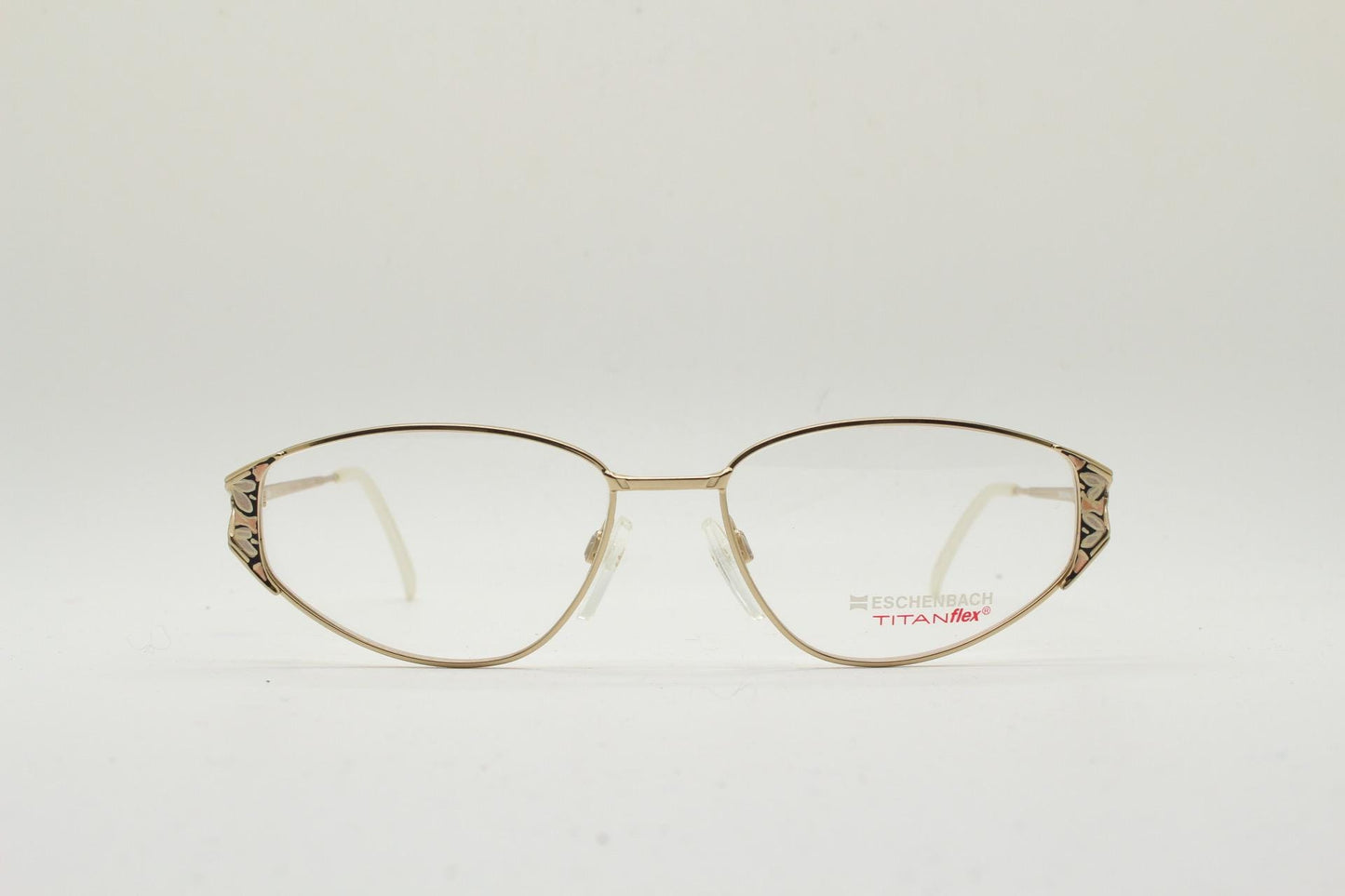 Eschenbach 90s vintage cropped cat eye glasses. Low profile gold metal optical frame with tasteful metallic arm pattern. Prescription. NOS