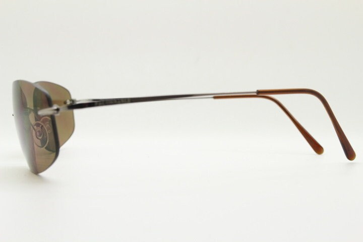 Faconnable 90s vintage sunglasses model 859 hand made in Italy. Minimal frameless design with flexible wire arms and brown chrome trim. NOS