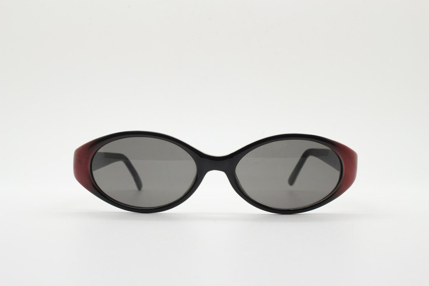 Vintage 90s oval sunglasses with very unique abstract arm pattern in black and red on layered acetate. Authentic original design. NOS