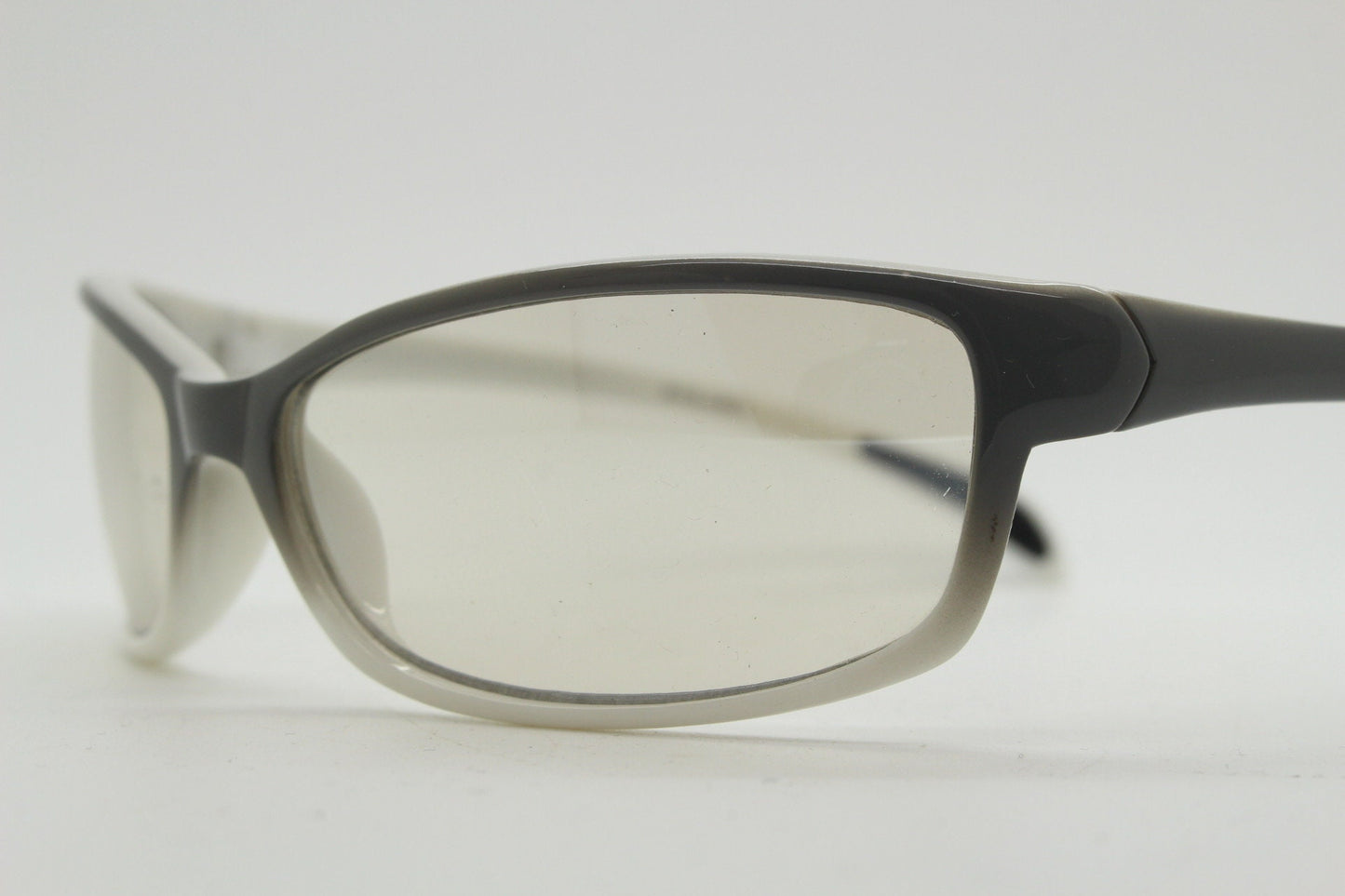 Y2K vintage futuristic sunglasses. Gloss white and grey wrap around shield style frame with light tone lenses. Cosplay visor. 2000s NOS